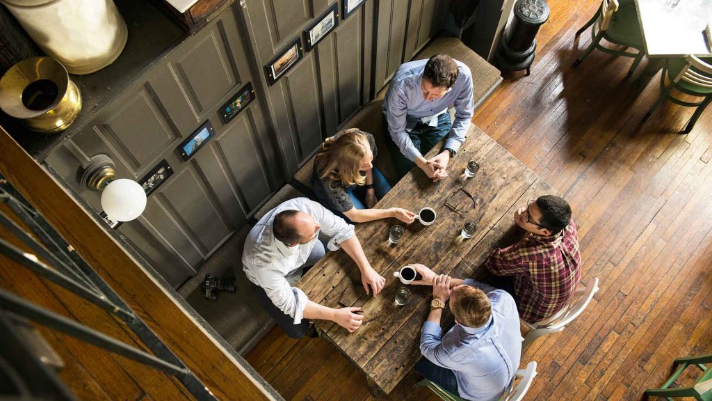 post-motion-graphics-designer-master-1024x576 team meeting at table